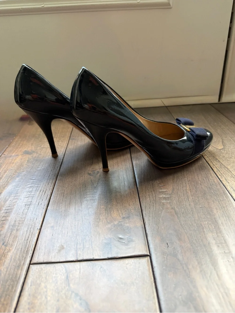 Salvatore Ferragamo Navy Patent Pumps with Navy Bow and Gold Plaque